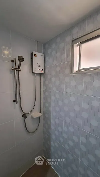 Modern bathroom with sleek shower and geometric tile design