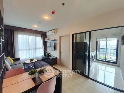 Modern living room with balcony view and stylish decor in a high-rise apartment.