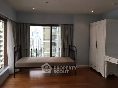 Spacious bedroom with city view and elegant furnishings