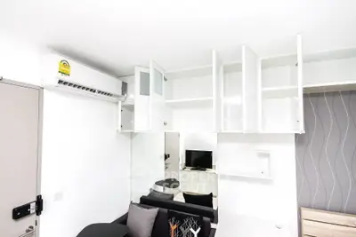 Modern compact living room with open cabinets and air conditioning