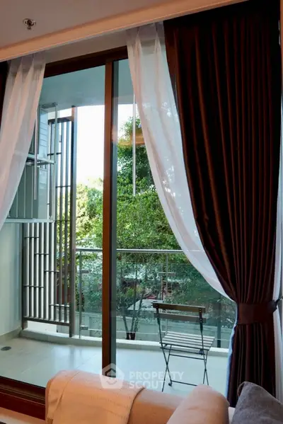 Chic apartment balcony with elegant curtains and serene outdoor view