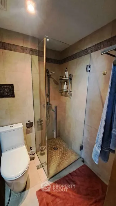 Modern bathroom with glass shower enclosure and elegant tile design