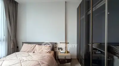 Modern bedroom with sleek wardrobe and cozy bedding in a stylish apartment.