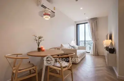 Chic modern living room with cozy seating and dining area, featuring elegant decor and natural light.