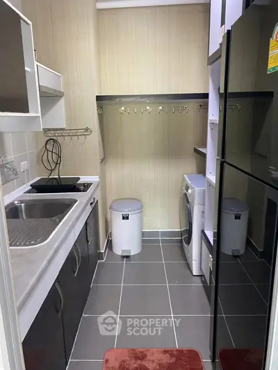 Compact kitchen with modern appliances and efficient layout in urban apartment