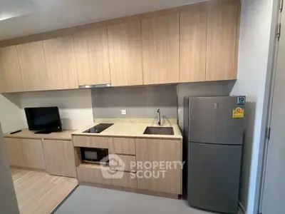 Modern kitchen with sleek cabinetry and built-in appliances in a stylish apartment.