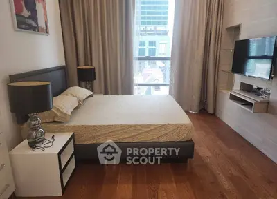 Modern bedroom with city view, featuring sleek design and cozy ambiance.