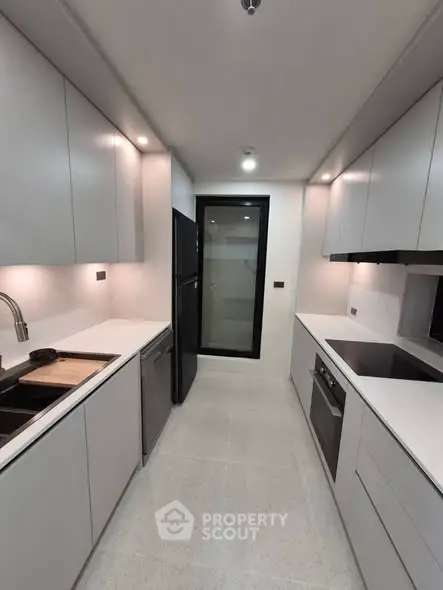 Modern kitchen with sleek cabinetry, built-in oven, and spacious layout for culinary enthusiasts.