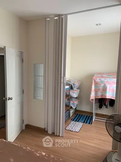 Cozy bedroom with sliding partition and organized storage space