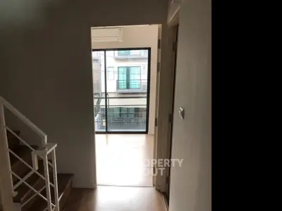 Modern townhouse interior with balcony view and wooden flooring