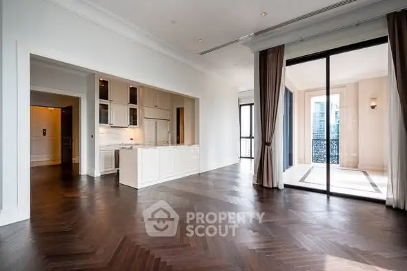 Luxurious open-plan living room with elegant hardwood floors and balcony view.