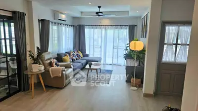 Spacious modern living room with large windows and stylish decor
