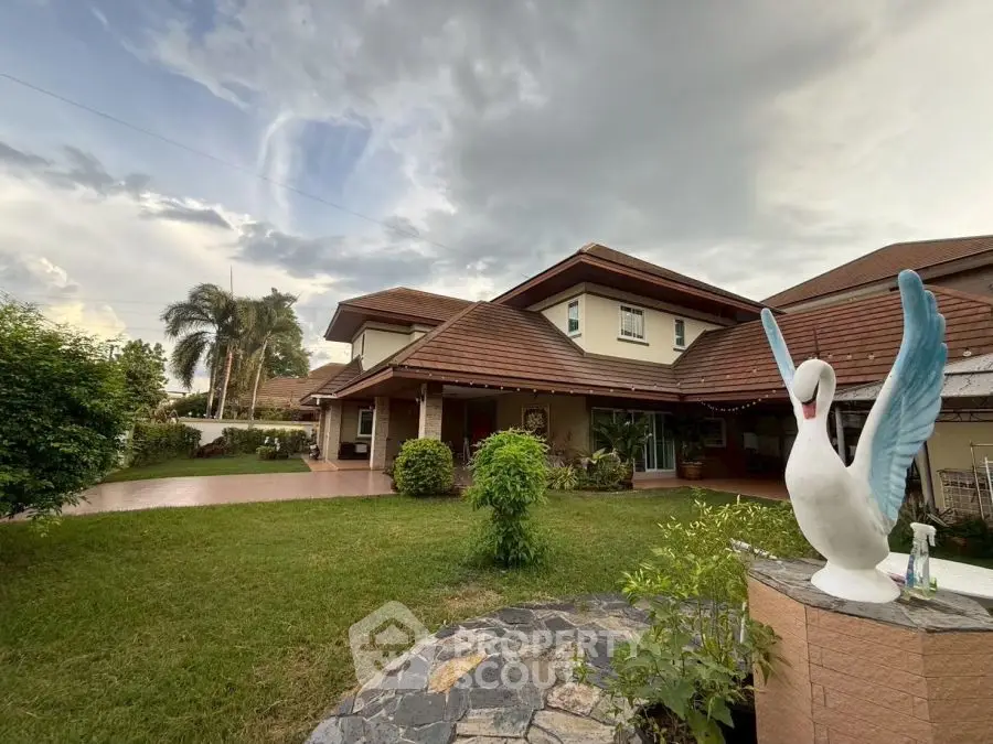 Charming suburban home with lush garden and unique swan sculpture in tranquil neighborhood.