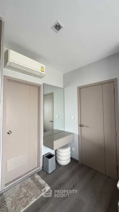 Modern bedroom with sleek design, featuring air conditioning and minimalist decor.