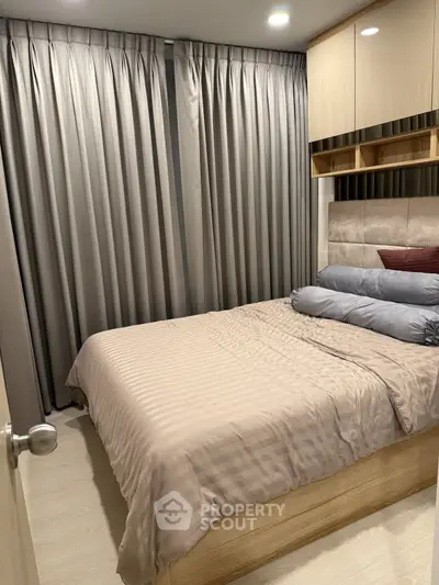 Cozy bedroom with elegant curtains and modern furnishings, perfect for restful nights.