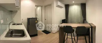 Modern studio apartment with open kitchen and stylish bar seating