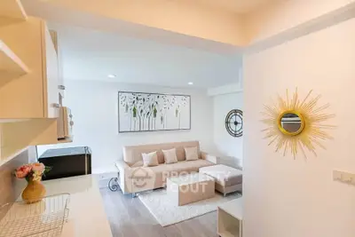 Modern living room with stylish decor and comfortable seating in a bright, open space.