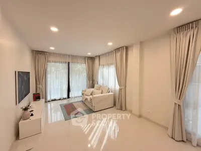 Spacious living room with modern decor and large windows for natural light