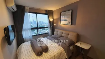 Cozy bedroom with city view, modern decor, and natural light in urban apartment.