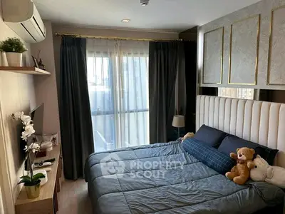 Cozy bedroom with modern decor, plush bedding, and natural light from large window.