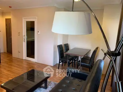 Modern living room with sleek furniture and wooden flooring in a cozy apartment.