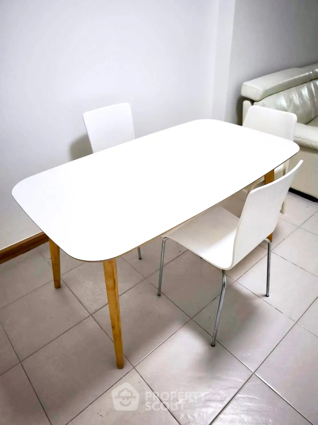 Modern dining area with sleek white table and chairs, perfect for contemporary interiors.