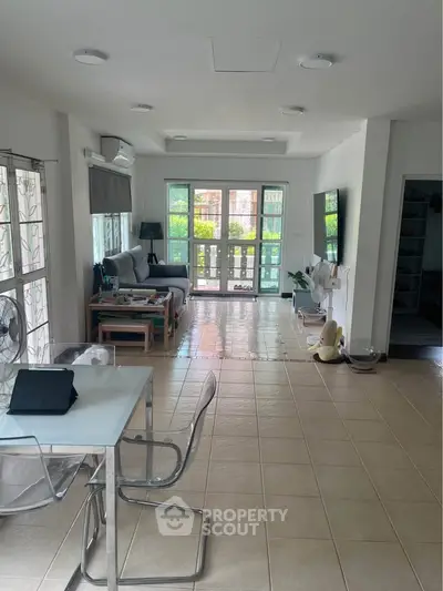Spacious living room with modern decor and large windows offering natural light.