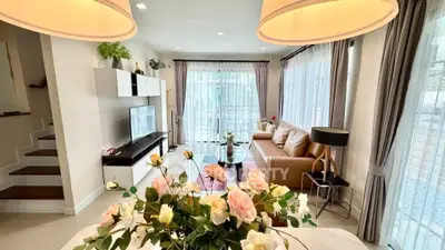 Elegant living room with modern decor and large windows for natural light