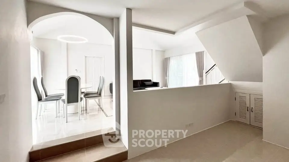 Modern open-plan living and dining area with sleek design and natural light.