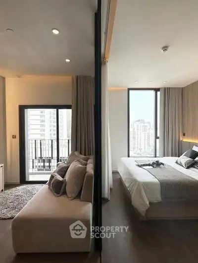 Modern apartment with stylish living room and cozy bedroom, featuring large windows and city views.