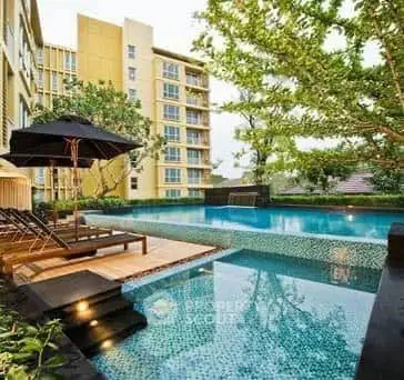 Luxurious apartment complex with stunning pool and lush greenery