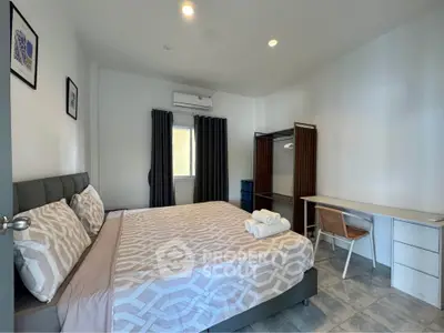 Spacious bedroom with modern decor and ample natural light