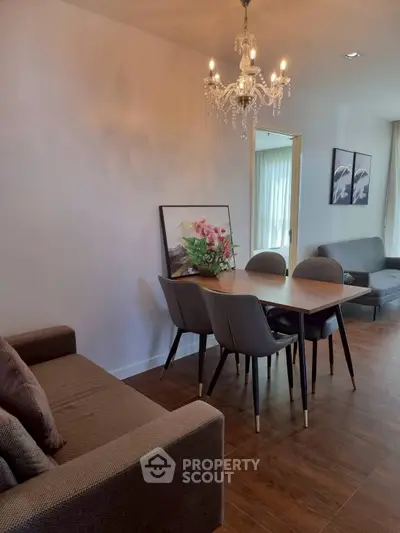 Elegant dining area with chandelier and modern decor in a cozy living space.