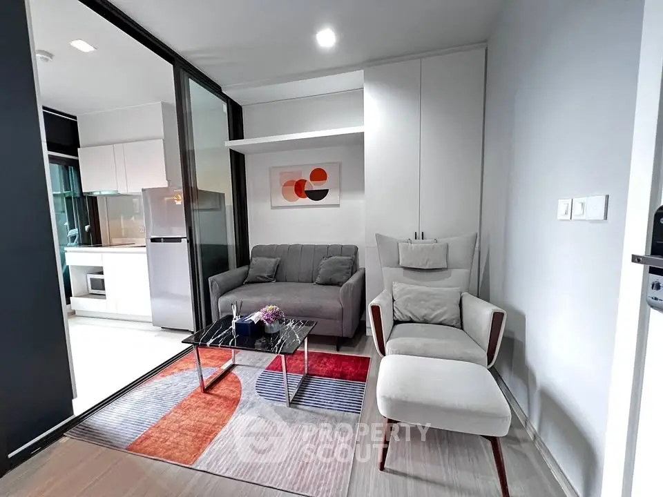 Modern living room with stylish furniture and open kitchen layout in a contemporary apartment.