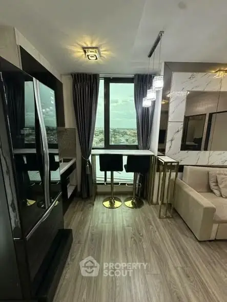 Modern living room with elegant decor and city view, featuring stylish furniture and floor-to-ceiling windows.