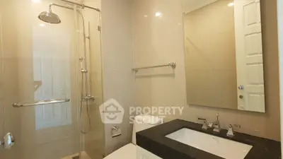 Modern bathroom with sleek fixtures and glass shower enclosure