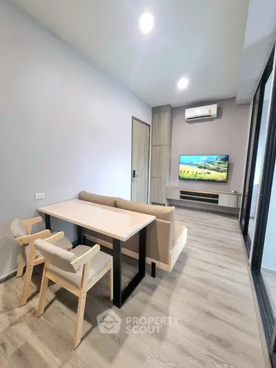 Modern living room with sleek furniture and large TV, perfect for relaxation.