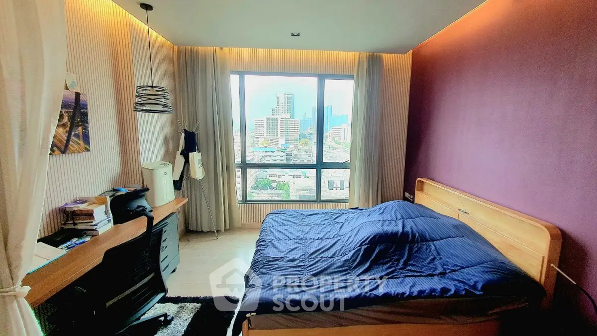 Spacious bedroom with city view, modern decor, and natural light