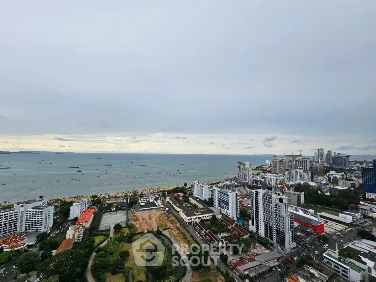 Stunning coastal cityscape view with high-rise buildings and ocean horizon.