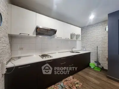 Modern kitchen with sleek cabinetry and electric stove in stylish apartment