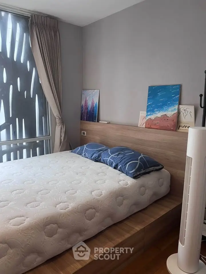 Cozy bedroom with modern decor and large window for natural light