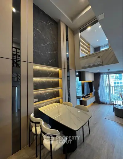 Luxurious modern living room with high ceilings and elegant marble accents in a stylish apartment.