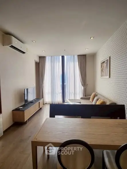 Modern living room with stylish furniture and large window view