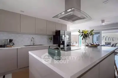 Modern kitchen with sleek cabinetry and island in open layout design.