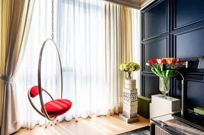 Stylish modern living room with hanging chair and elegant decor
