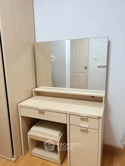 Modern bedroom with stylish wooden vanity and mirror, perfect for elegant living.