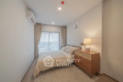 Cozy modern bedroom with large window and stylish decor