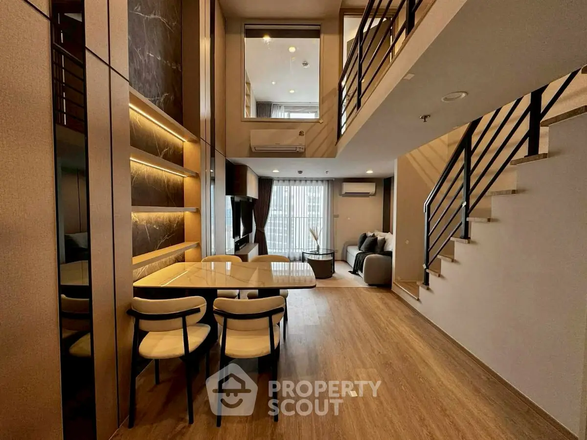 Luxurious modern duplex living room with elegant dining area and stylish staircase