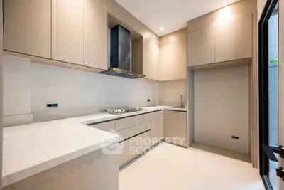 Modern kitchen with sleek cabinetry and gas stove in a contemporary home.