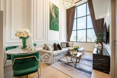 Luxurious high-ceiling living room with elegant decor and large window view.